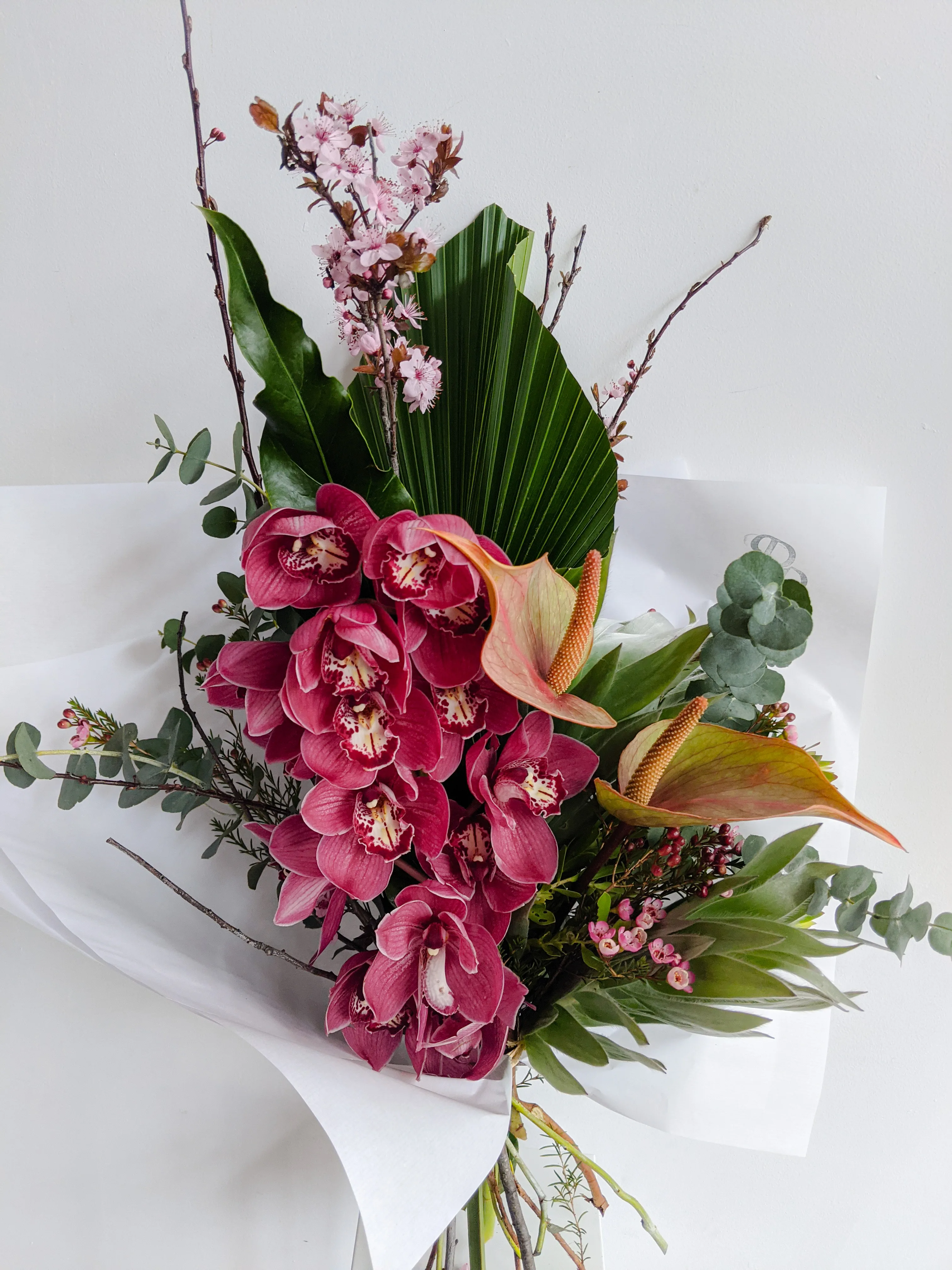 Dramatic tall magenta cymbidium orchid bouquet
