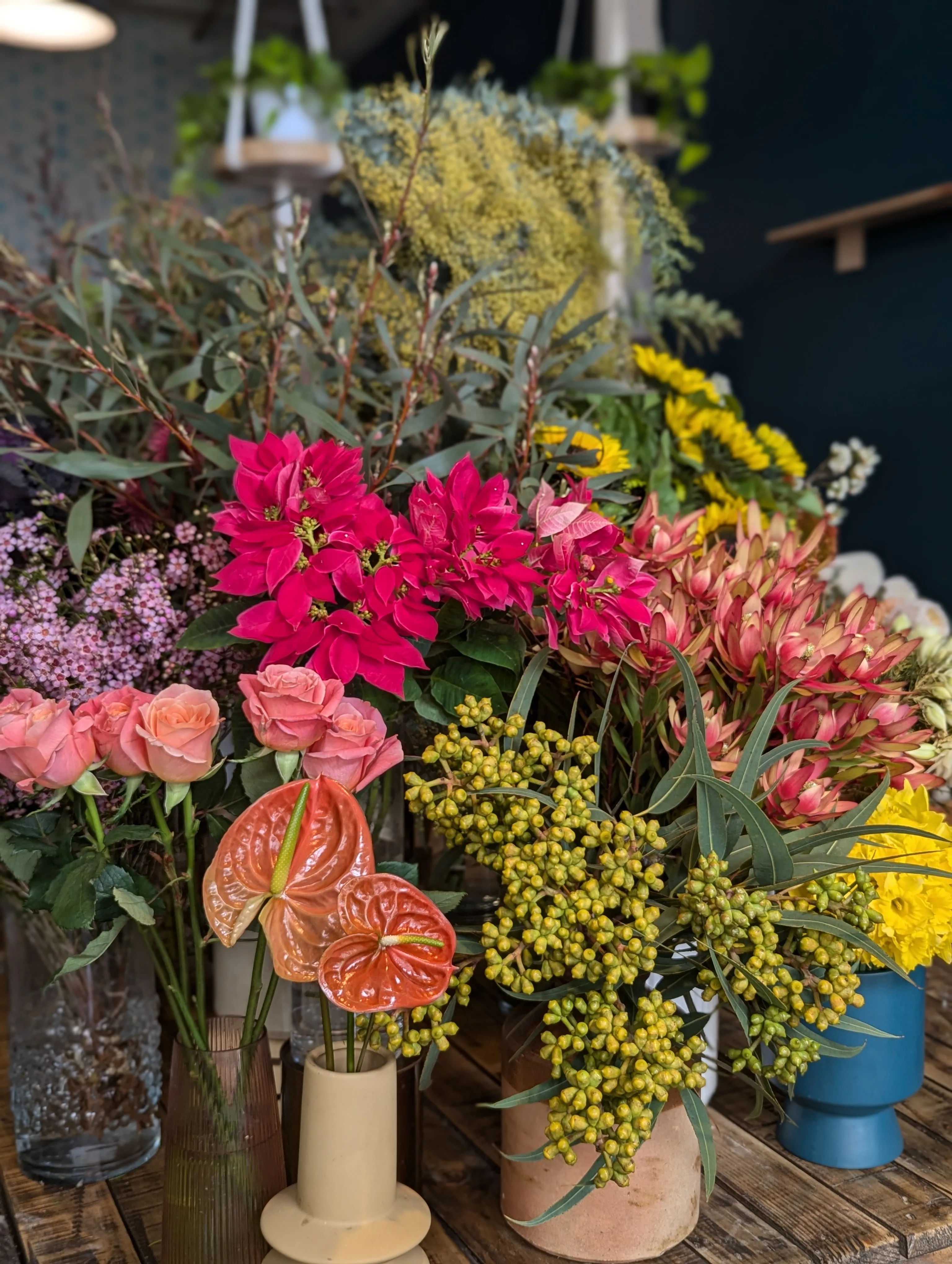Fresh-flower bucket display with roses, proteas and banksia